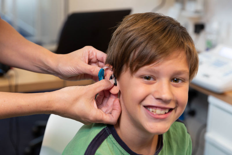 boy happy to have his new hearing aid boy happy to have his new hearing aid