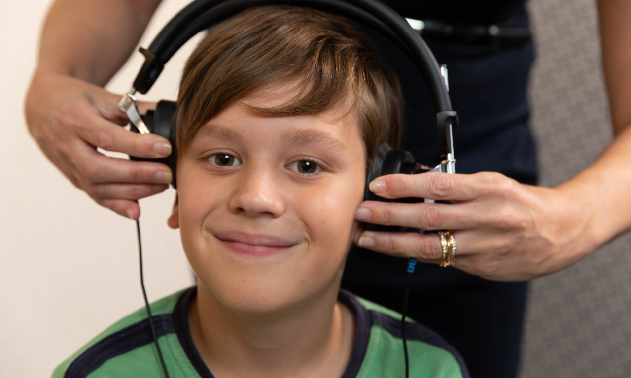 boy with headphones on getting hearing test boy with headphones on getting hearing test