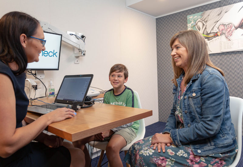 boy with mother at audiologists boy with mother at audiologists