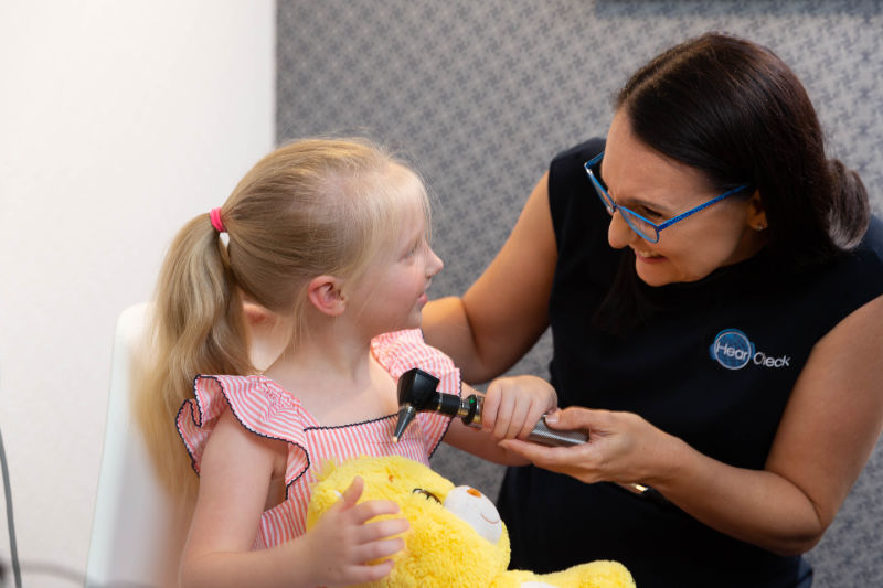 child enjoying playing with audiologist