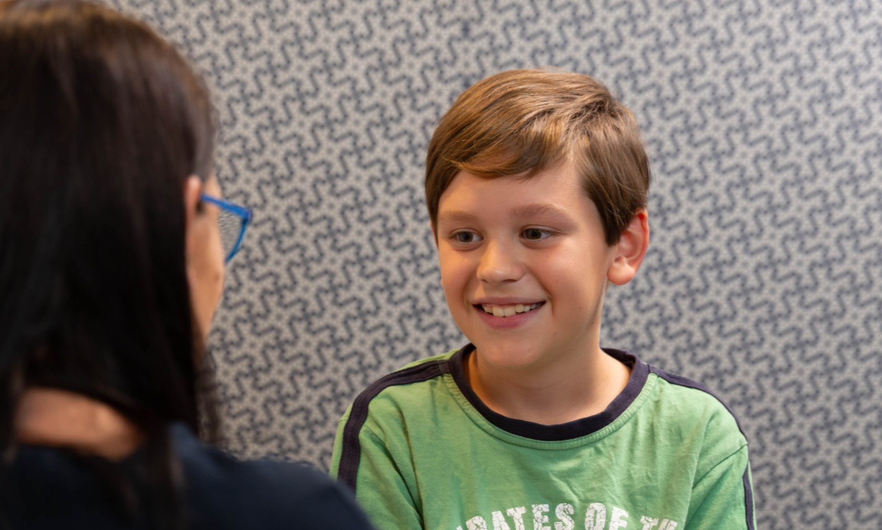 child with audiologist boy in green shirt child with audiologist boy in green shirt