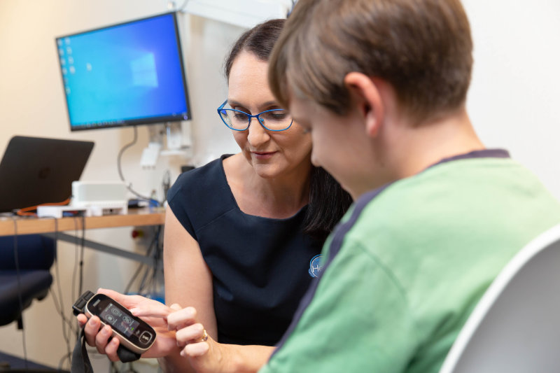 child with hearing aid being shown roger ald child with hearing aid being shown roger ald